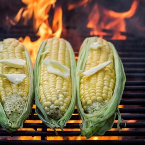 Closeup of fresh corn on grill with butter and salt